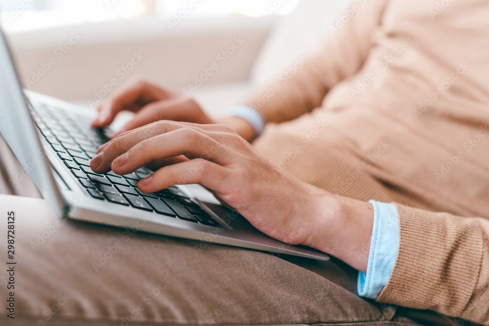 Leinwandbilder hands of young casual man touching keys of laptop keypad while networking