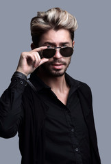 Close-up portrait of handsome stylish man in sunglasses.