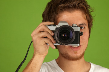 Young man taking photograph in studio