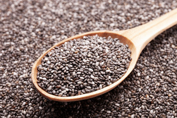 Chia seeds in wooden spoon closeup view. Super food concept