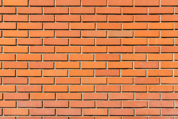 texture of an orange brick wall, building facade is made of facing brick.