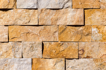 beige colour stone wall from tiles natural granite texture.