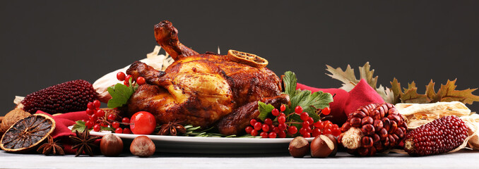 Baked turkey or chicken. The Christmas table is served with a turkey, decorated with fruits, salad and nuts. Fried chicken, table. Christmas