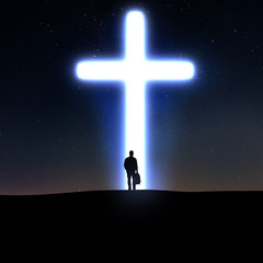 Man and cross at night