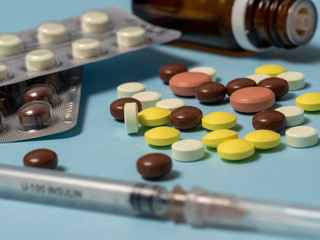 Medical supplies and syringe on a blue background. Concert of medicine, help for patients