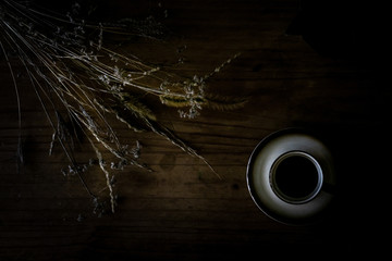 bouquet and coffee on a rustic chest