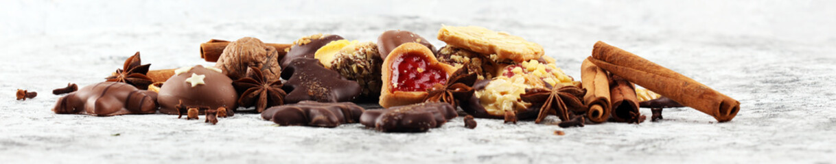 christmas cookies with spieses, nuts and fruits on rustic table