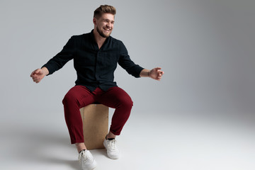 Cheerful fashion man laughing and welcoming
