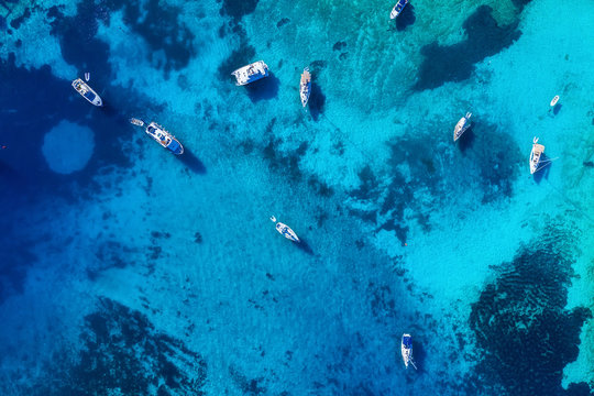 Boats from air. Aerial view on sea. Summer seascape with clear water in sunny day. Top view of boats from drone. Summer seascape from air. Travel - image
