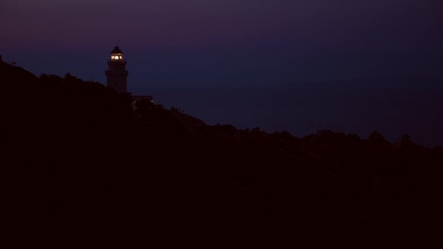 lighthouse silhouette at night