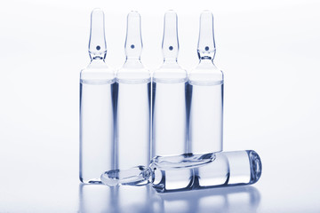 Glass medicine ampoules on a white background