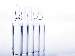 Glass medicine ampoules on a white background