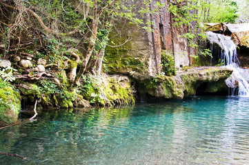 Fototapeta na wymiar Small waterfalls created from the spring of the Bussento river, Casaletto Spartano, Salerno Italy.