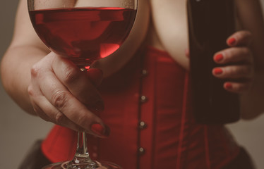love date. erotic games. woman in corset with sexy chest drink red wine. alcohol drink. Sexy reality. lets celebrate. Perfect body in sexy lingerie. cheers. to us. Sexy female fetish-wear. Hot babe