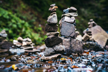 Rock, petro, stone photography. Stony shore of river with waterfall. Autumnal season forest. Rocky turret and waterfall landscape. Copy space. Wallpaper background.
