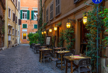 Fototapeta na wymiar View of old narrow street in Rome, Italy. Architecture and landmark of Rome. Cozy cityscape of Rome.