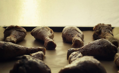 Baked chicken in the oven. Turkey legs on a baking sheet with spices baked in the oven. Snack on Thanksgiving Day.