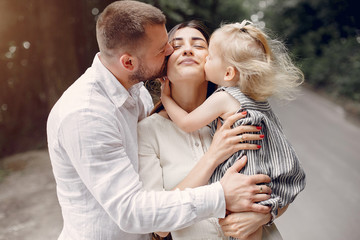 Family in a summer park. Mother and little daughter playing. Cute little girl with a father