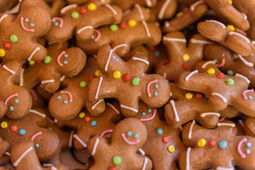 Gingerbread men cookies, decorated with white icing. Funny and happy festive table for Christmas and winter holidays