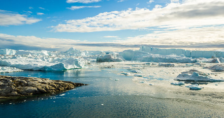 Iceberg and ice from glacier in arctic nature landscape on Greenland. Aerial image drone image of icebergs in Ilulissat icefjord. Affected by climate change and global warming.