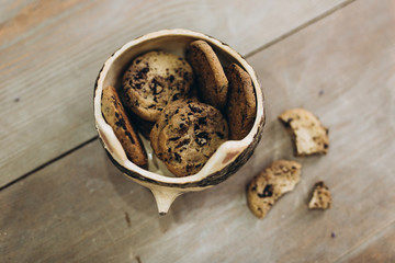 Handmade dishes with cookies on wooden table. Ceramist concept