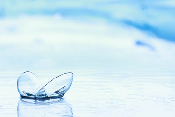 Tools for vision correction. Glasses and lenses with diopters on the background of splashes and blurry.