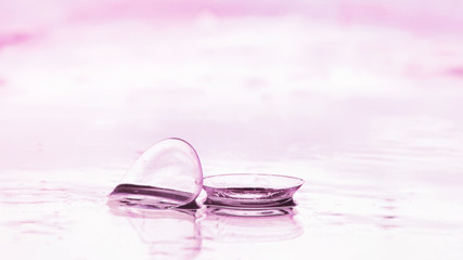 Tools for vision correction. Glasses and lenses with diopters on the background of splashes and...