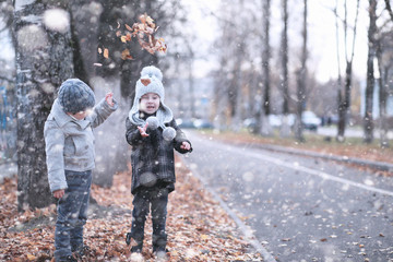 Kids walk in the park first snow