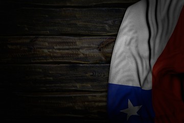 Fototapeta na wymiar beautiful holiday flag 3d illustration. - dark image of Chile flag with big folds on old wood with empty place for content