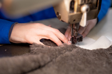 Sewing details of fur and leather. Shoe production.