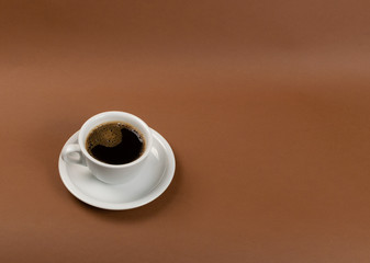 Hot coffee cup on brown background close up