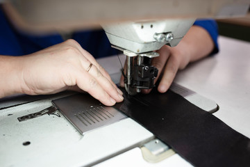 The process of sewing shoes on a sewing machine. Shoe production.