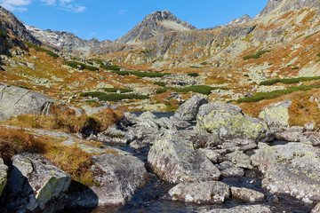 Pleso nad Skokom, the lake above Skok waterfall in High Tatras National Park with rocks in the water and peaks in the background, in Slovakia © andras_csontos