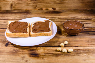 Two sandwiches with chocolate spread on a white plate
