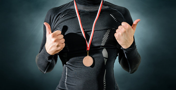 The athlete enjoys the bronze medal, third place. Player happy to win a bronze medal. The concept of tournaments and competitions. Victory, winning competitions.