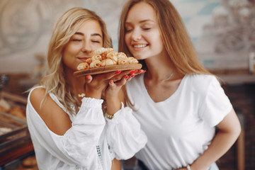 Girls at the bakery. Ladies with cake. Blonde in a white shirt