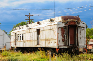 An old neglected rail car sitting by itself showing the wear of time