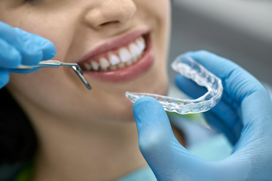Pretty woman's teeth treatment in dental clinic