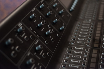 Audio sound mixer console. Audio mixer, music equipment. broadcasting tools, mixer, synthesizer. and computer control.Professional sound and audio mixer control panel with buttons and sliders.