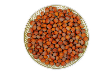 Nuts in a plate isolated on white background. Healthy vegan vegetarian snack or ingredient for cooking, hazelnuts.