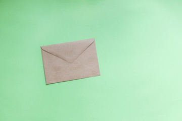 Kraft paper envelopes on a green background. Perfect for invitations, card, message decorations