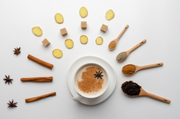 Traditional indian masala chai tea with spices - cinnamon, cardamom, anise, ginger white background. Top view - obrazy, fototapety, plakaty
