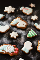 Christmas gift gingerbread on dark background.  Christmas gingerbread cookies with icing sugar. Top view