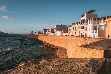 Fototapeta na wymiar ALGHERO, ITALY/ OCTOBER 2019: Wonderful sunset over the ancient fortifications