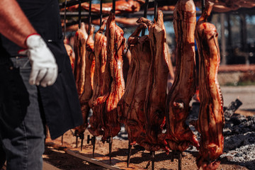 Fototapeta na wymiar ORGOSOLO, SARDINIA /OCTOBER 2019: The old tradition of cooking the Porceddu Sardo, a young pig.