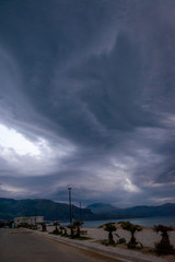 Spectacular gray cumulonimbus clouds above sea during dawn light