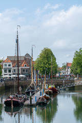 View on fishing harbor and old Dutch houses and tower in Zierikzee, historical town in Zeeland, Netherlands