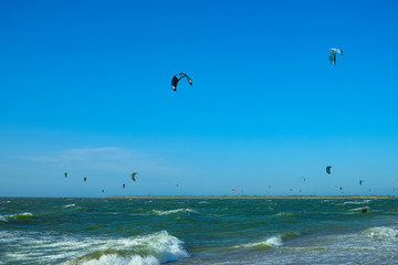 Water sport event, kite surfers race in North Sea near Renesse, Zeeland, Netherlands