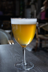 Famous Belgian beer served outside in small old cafe in special Belgian beer glass