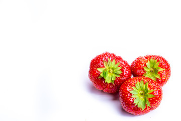 Three red ripe strawberries isolated on white background